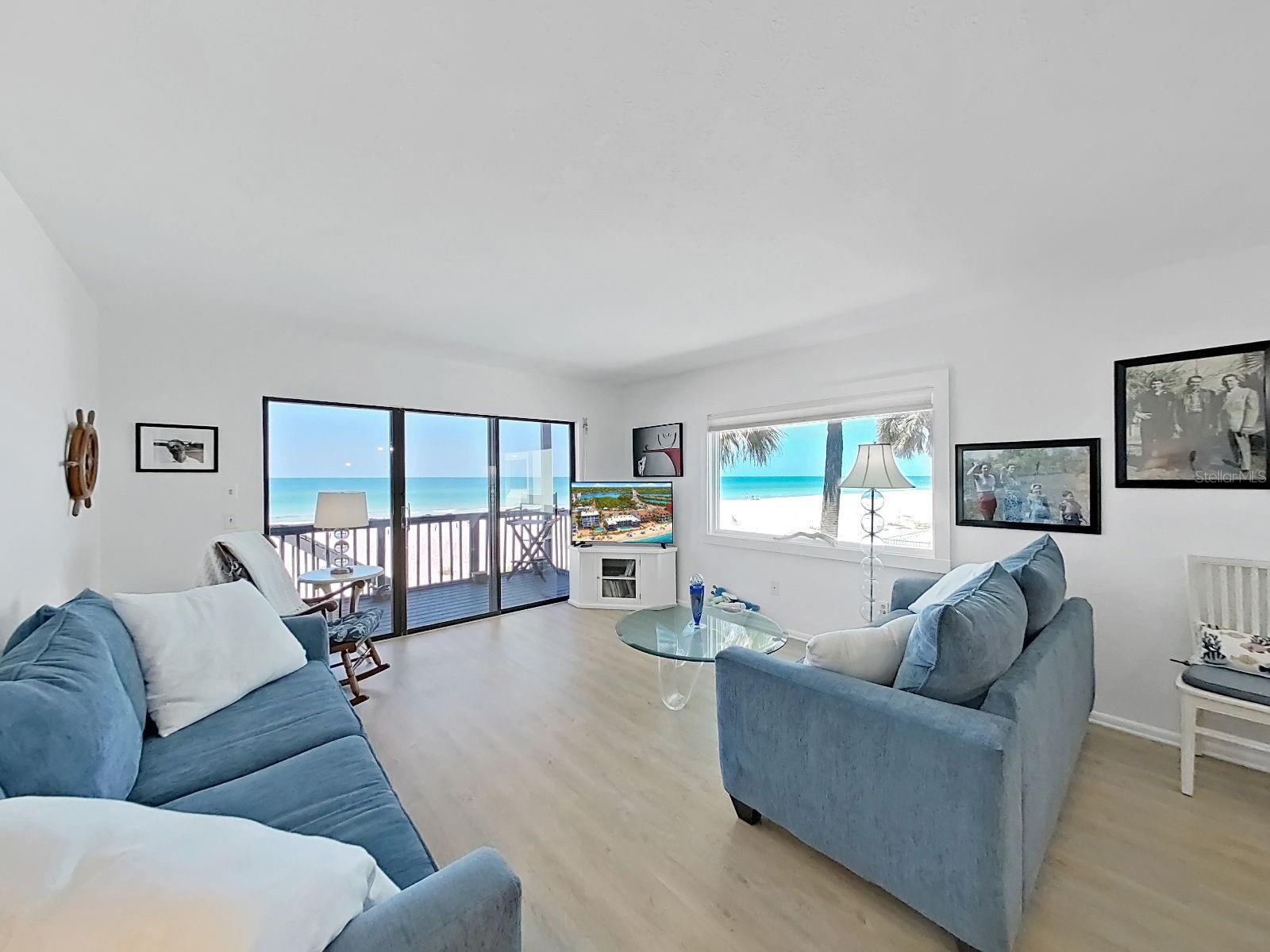 Great room has breathtaking water views.  You can watch the sunset right from your sofa.