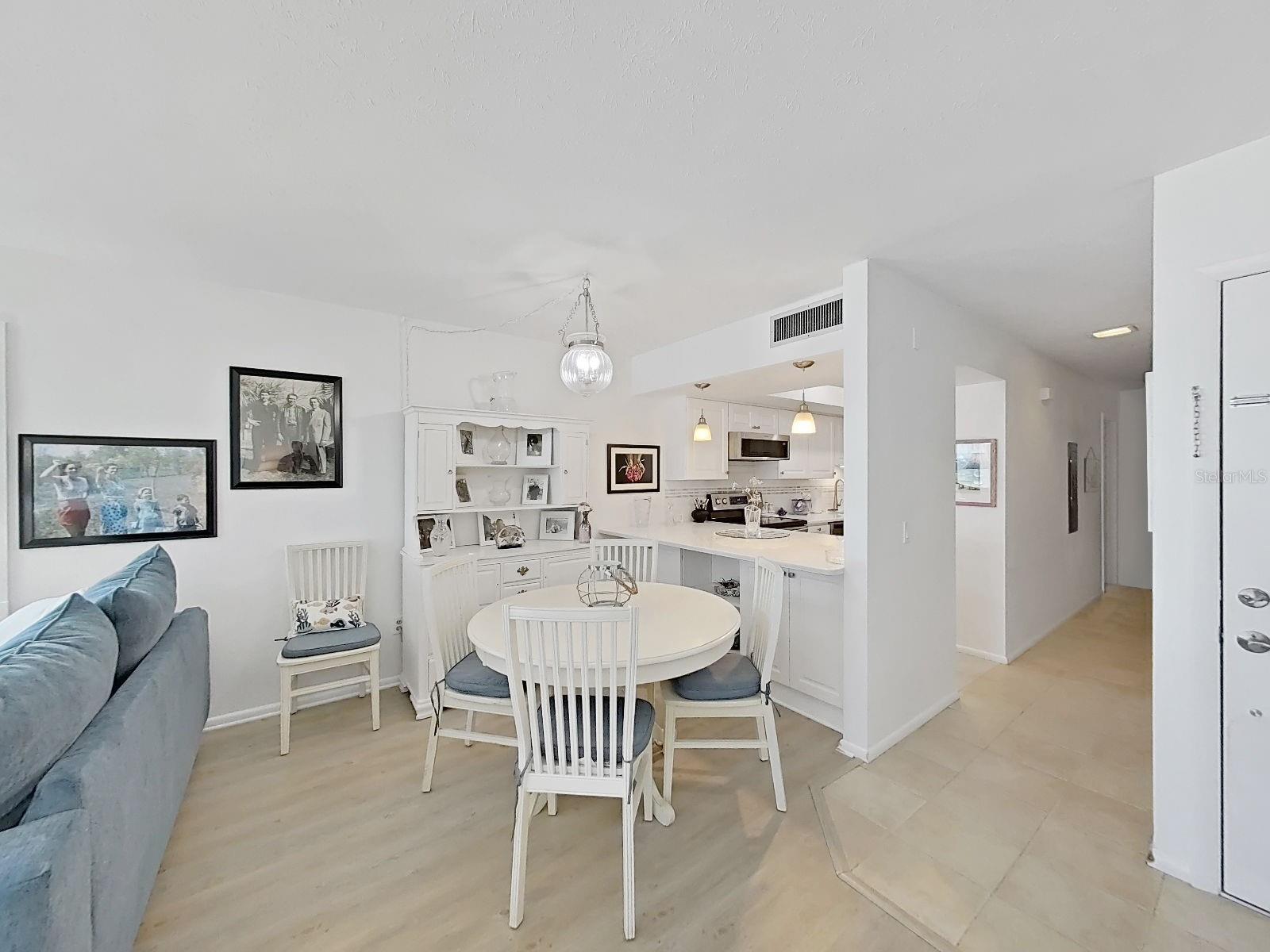 Dining /Great room combo with counter height kitchen bar top. Kitchen overlooks dining/great room.