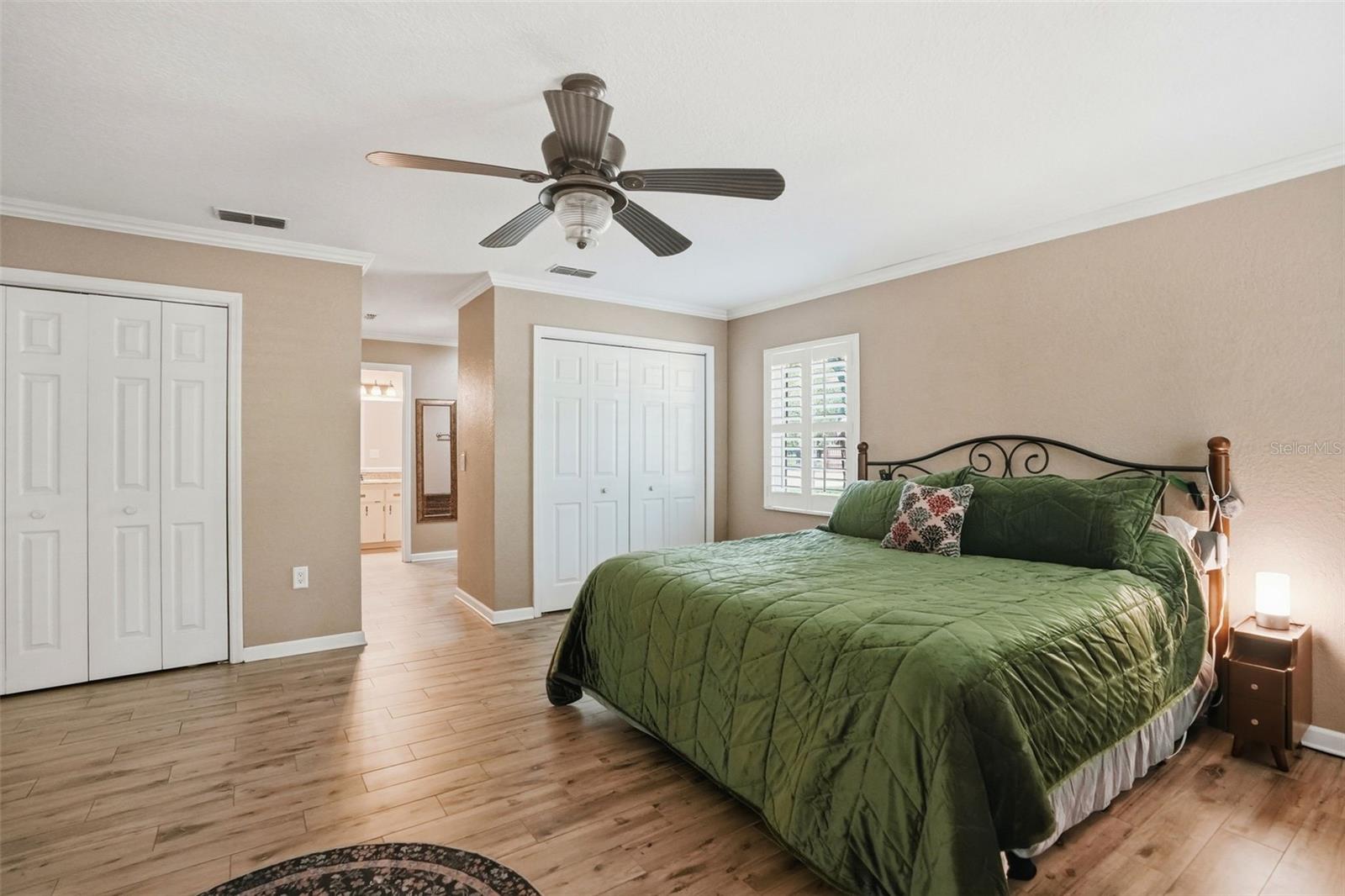 Oversized Primary Bedroom with Easy to Maintain Wood-Look Tile Floors, 3 Walk-in Closets, 2 Double Door Linen Closets and 2 separate vanity countertops with sinks