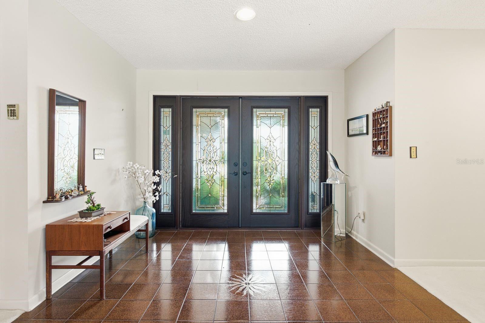 Double entry full glass doors with sidelights to maximize the light