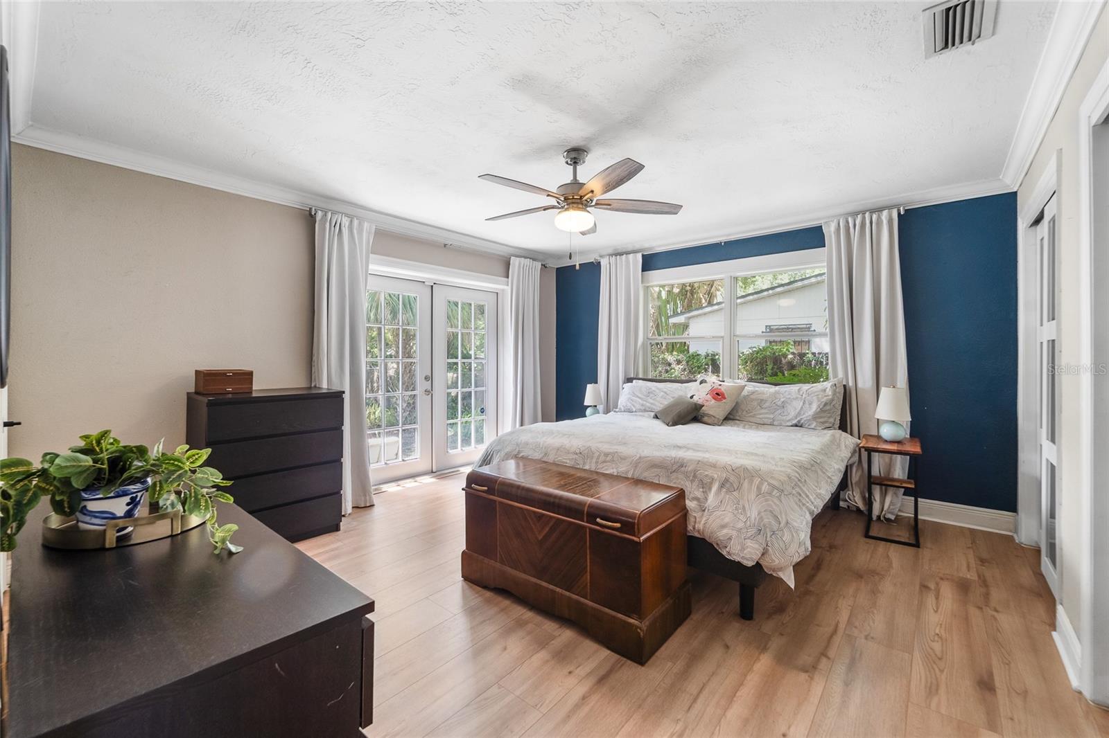 Primary bedroom French doors leading to the back yard