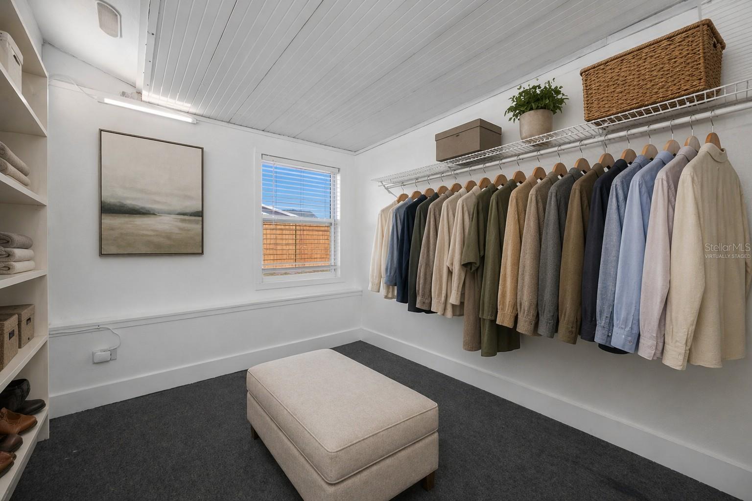 Virtually Staged Primary Bedroom Walk-in Closet