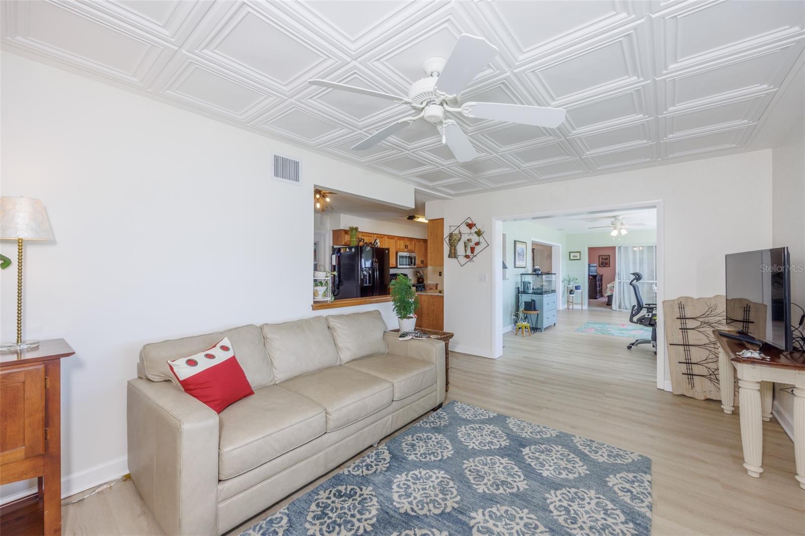 Great Room, Classic Elegance Coffered Ceiling & Electric Fireplace, LVT Plank Flooring