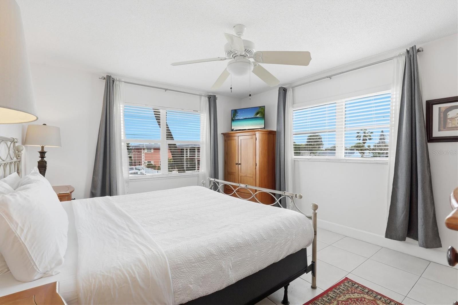 Primary bedroom with an en suite bathroom for privacy. Being an end unit gives you more windows and light.