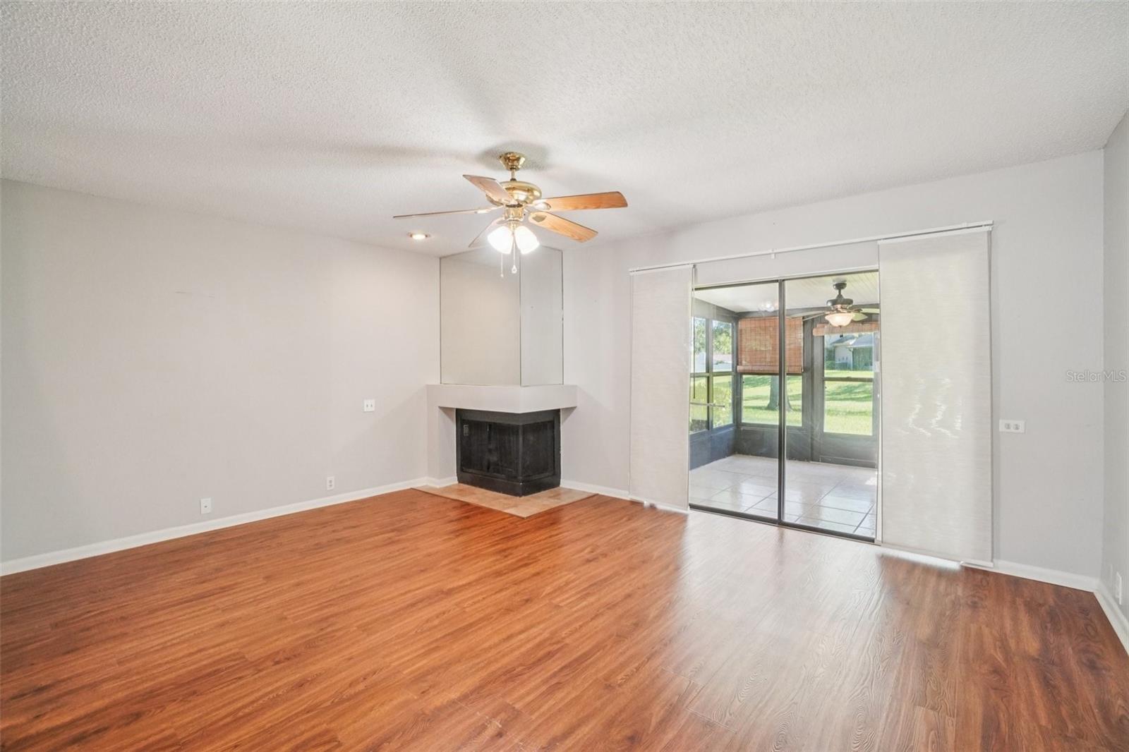 LIVING ROOM/DINING ROOM COMBO HAS CORNER WOOD BURNING FIREPLACE