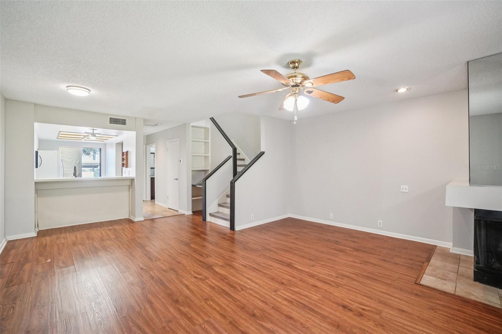 LIVING ROOM/DINING ROOM COMBO HAS CORNER WOOD BURNING FIREPLACE