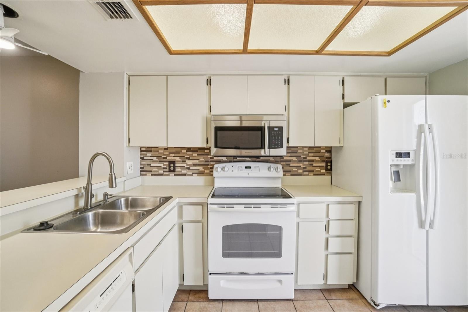 WELL LIT KITCHEN OVERLOOKS THE FRONT COURT YARD