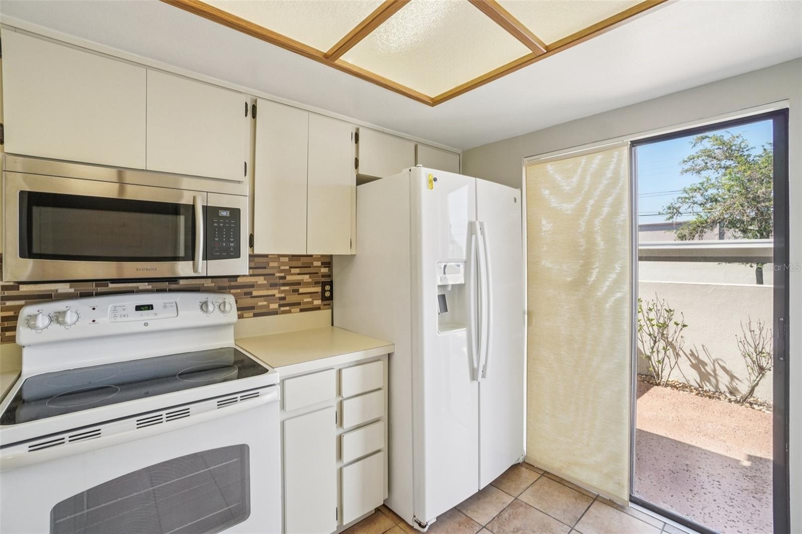 WELL LIT KITCHEN OVERLOOKS THE FRONT COURT YARD