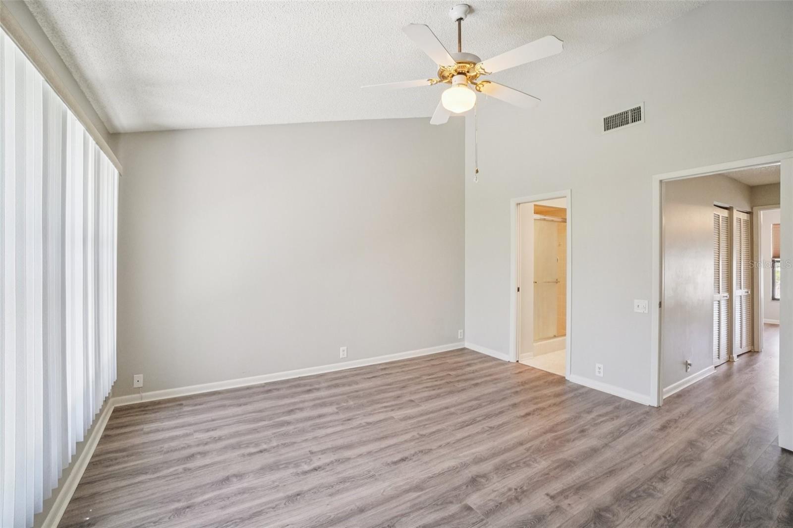 SPACIOUS PRIMARY BEDROOM OVERLOOKS BACK YARD