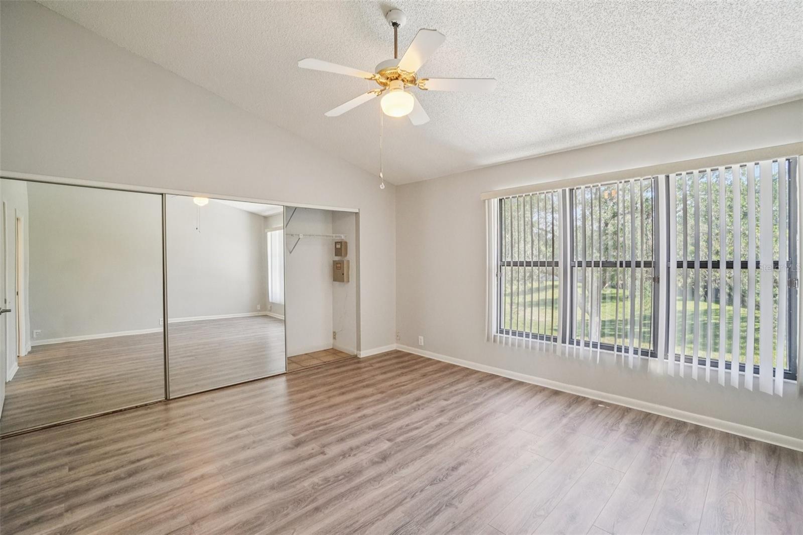 SPACIOUS PRIMARY BEDROOM OVERLOOKS BACK YARD! AND NO CARPET!