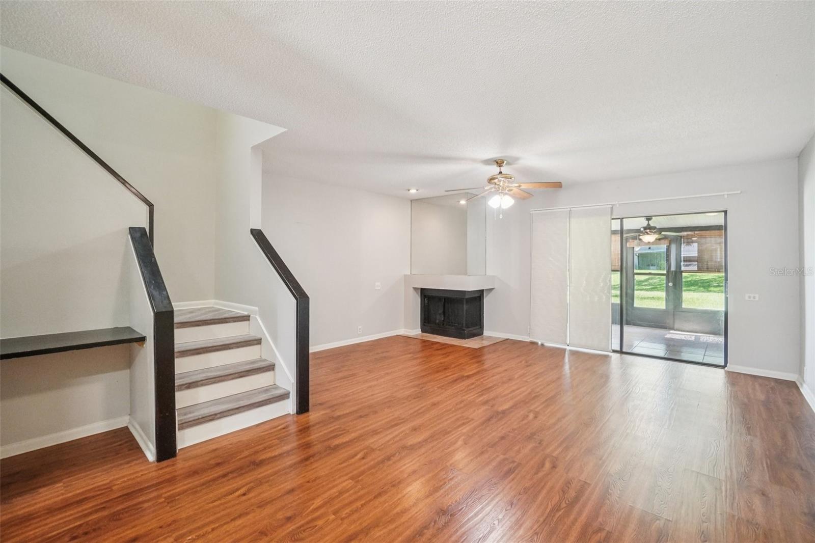 LIVING ROOM/DINING ROOM COMBO HAS CORNER WOOD BURNING FIREPLACE