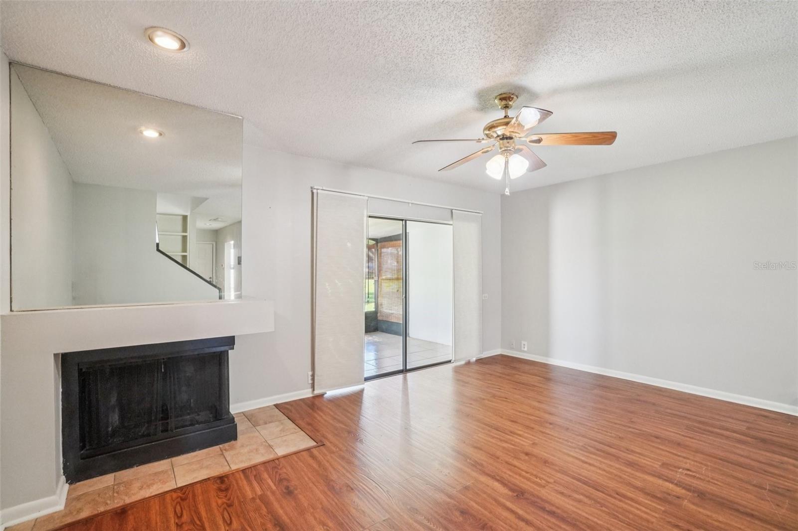 LIVING ROOM/DINING ROOM COMBO HAS CORNER WOOD BURNING FIREPLACE