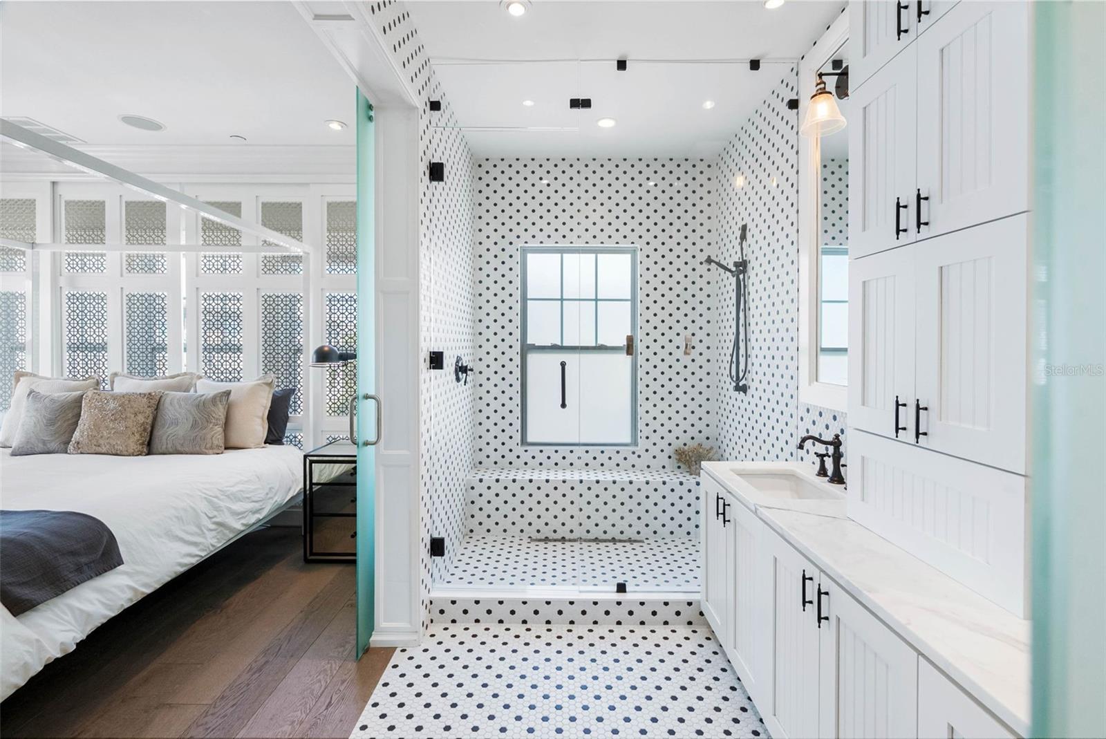 Floor to Ceiling Tile and custom cabinetry Walk in shower