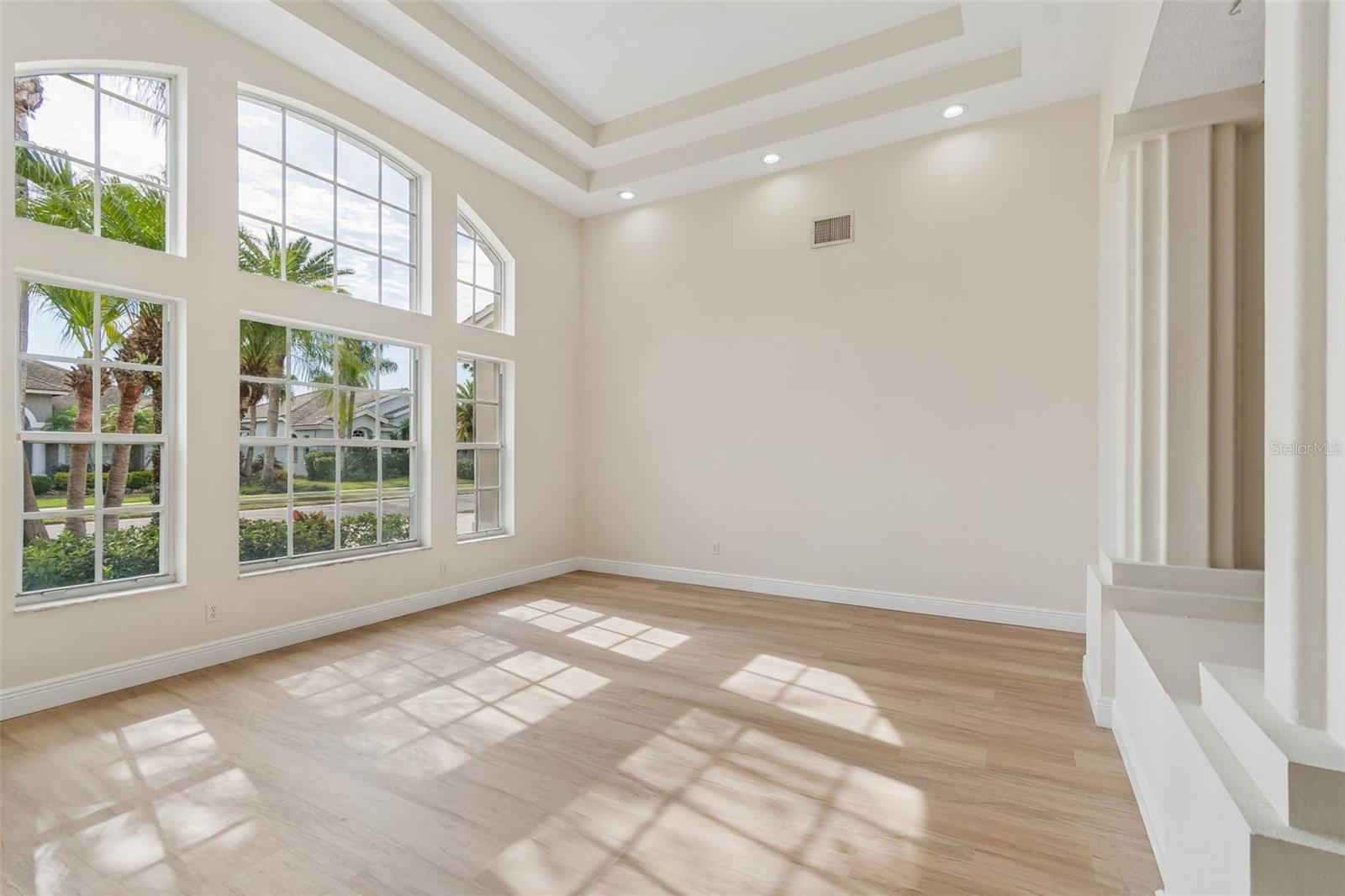 Gorgeous living room with massive ceilings and natural light throughout.