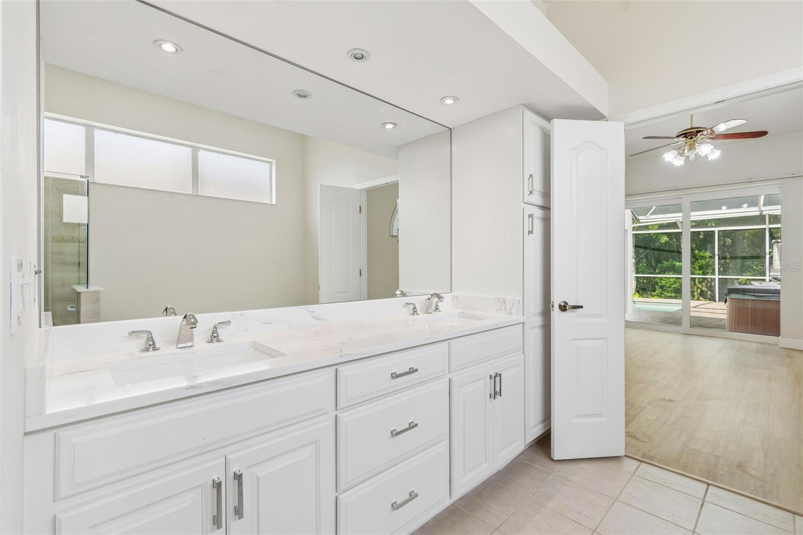 Freshly updated double vanity, fixtures, full mirror and linen closet enhance this spacious primary bath!