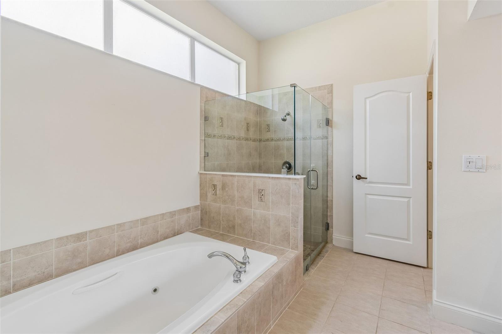 Boasts glass shower and private lavatory.