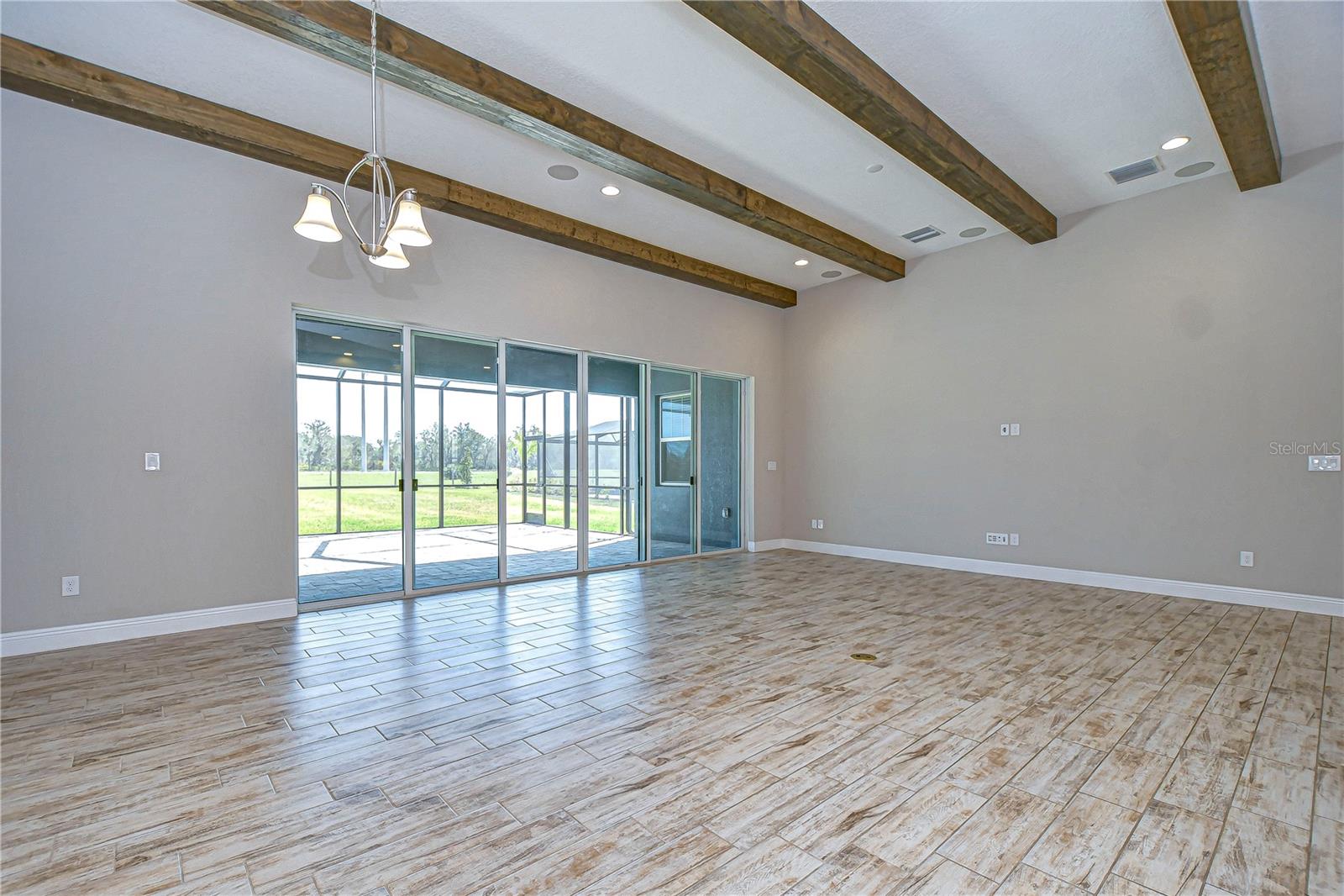 Spacious Great Room with Wood-Beamed Ceiling
