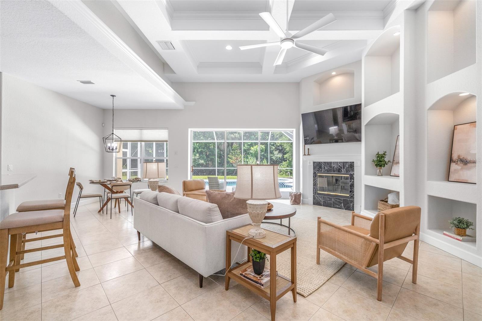 Large open-concept great room with tray/coffered ceilings