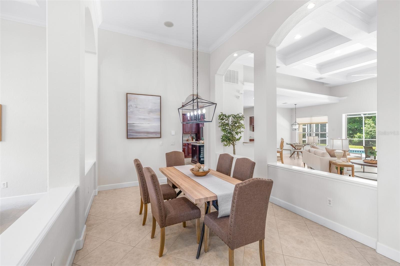 Spacious dining area overlooking the great room with soaring ceilings and abundant natural light