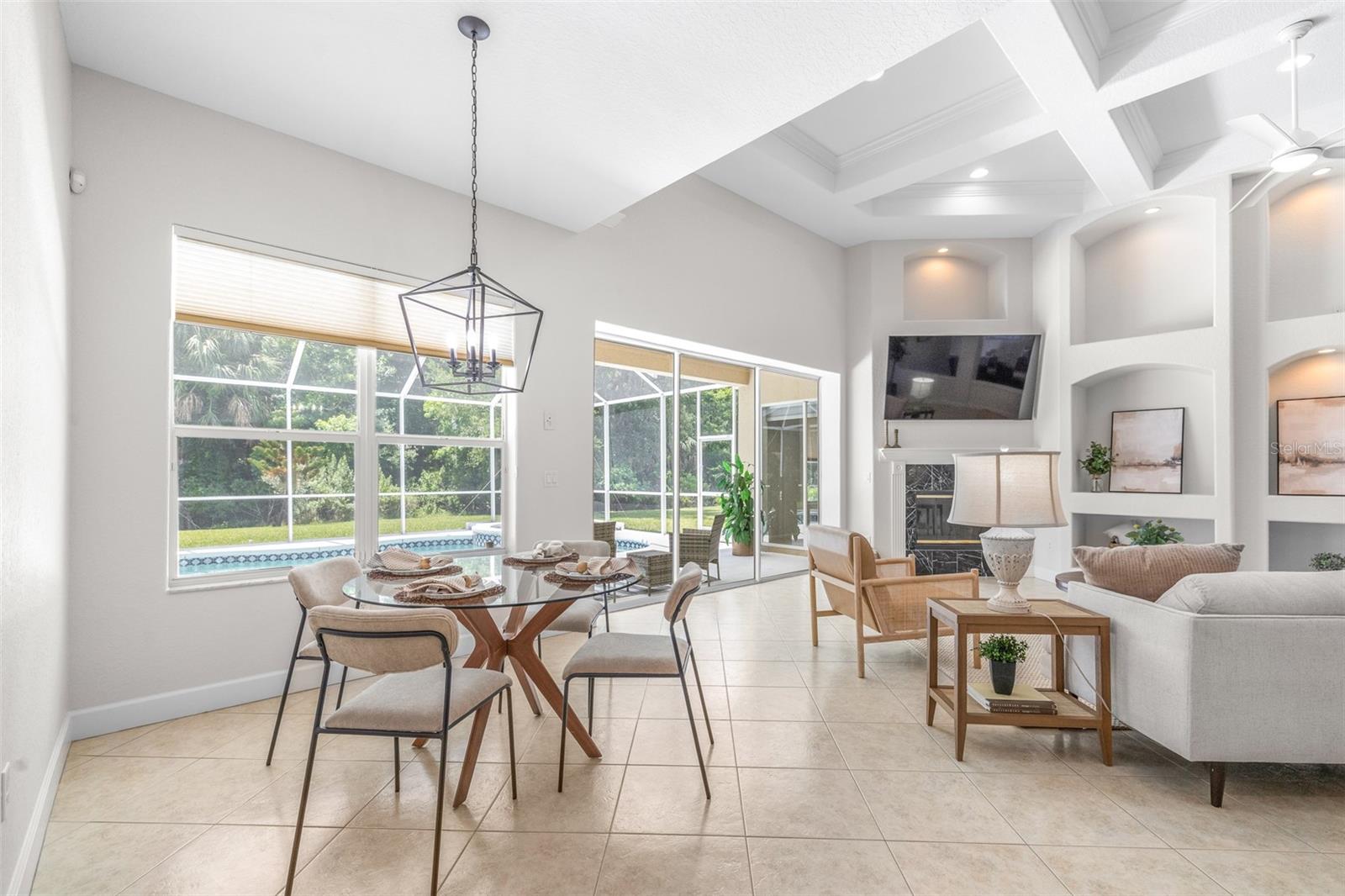 Breakfast nook overlooking the pool and conservation backdrop