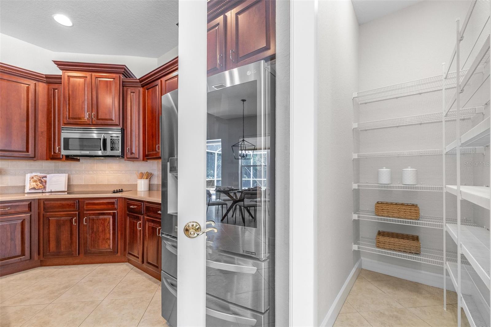Large walk-in pantry and abundant cabinetry provide exceptional kitchen storage