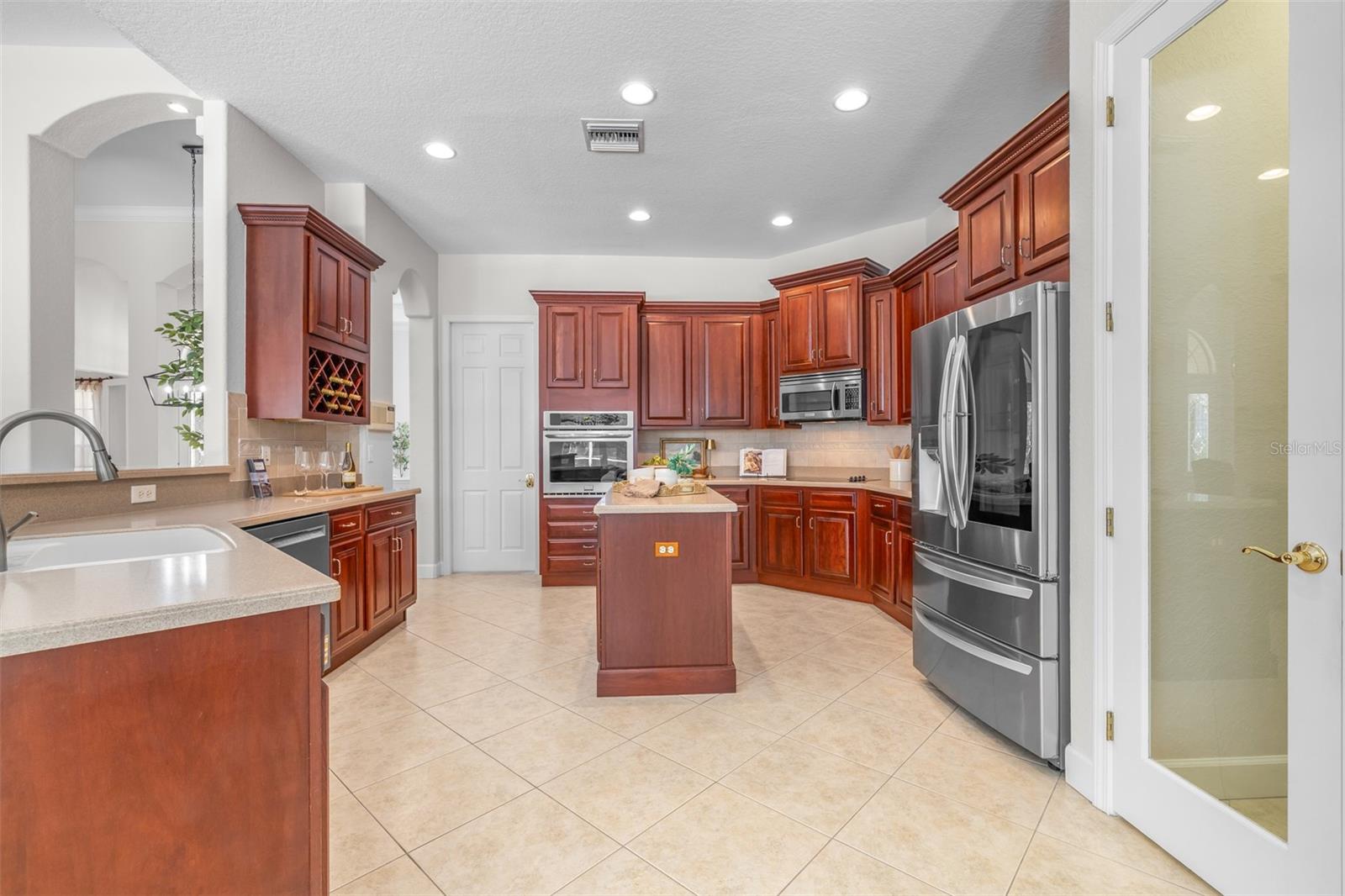 Spacious kitchen with rich wood cabinetry and center island
