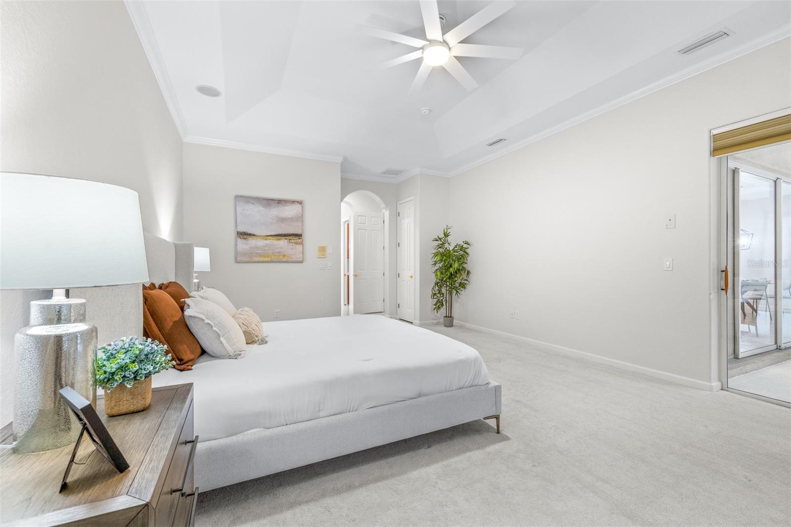 Oversized primary bedroom retreat with abundant natural light and peaceful ambiance