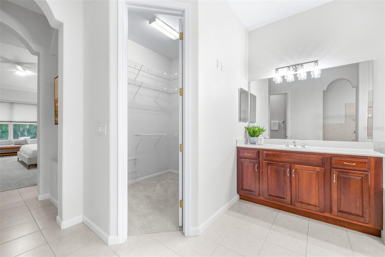 Expansive primary bathroom layout with separate vanities and spa-like atmosphere