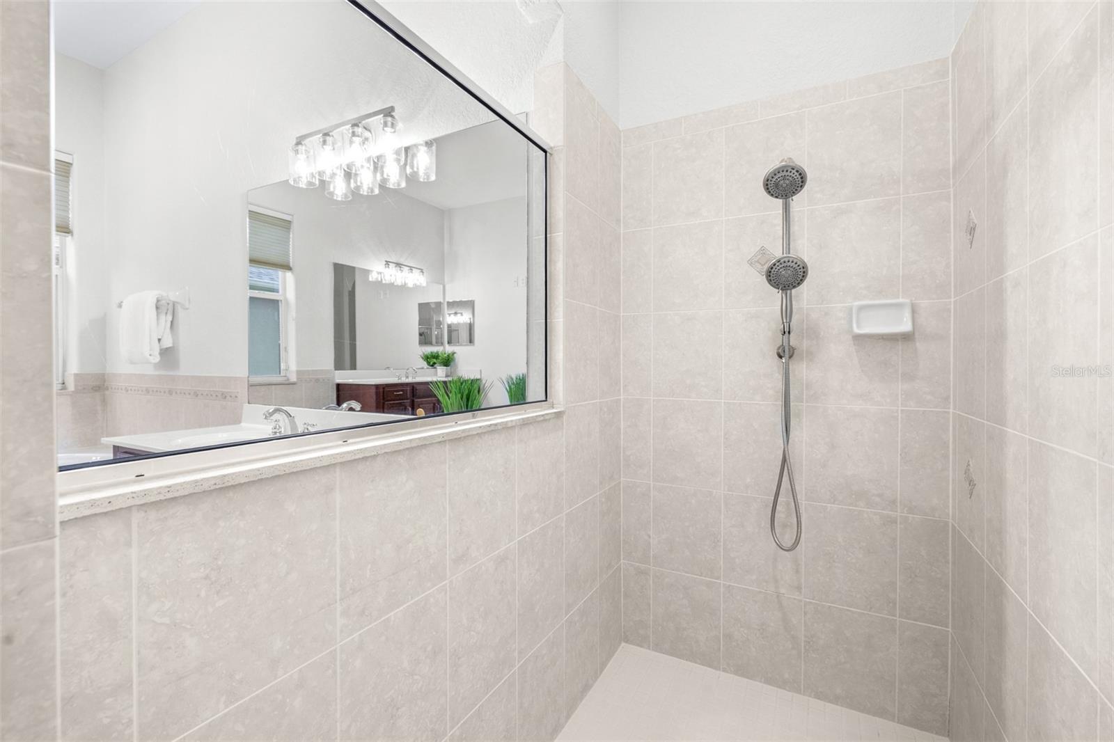 Large walk-in shower with bright finishes and spacious design