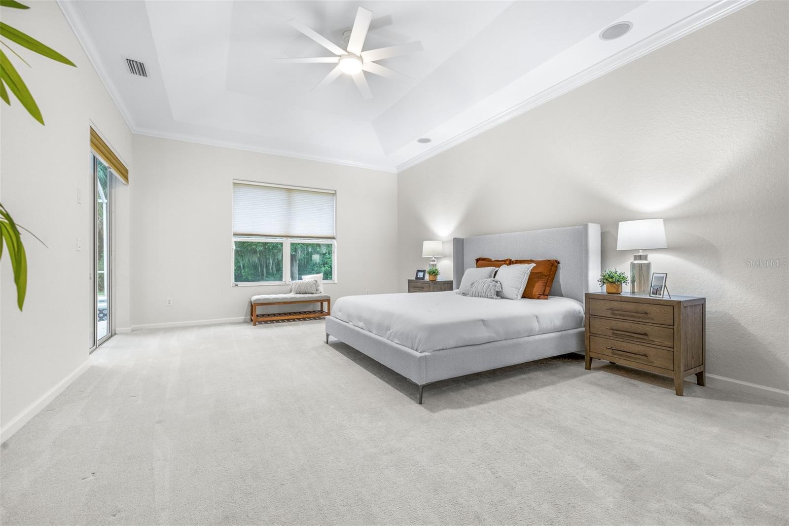 Primary bedroom with conservation view and pool access
