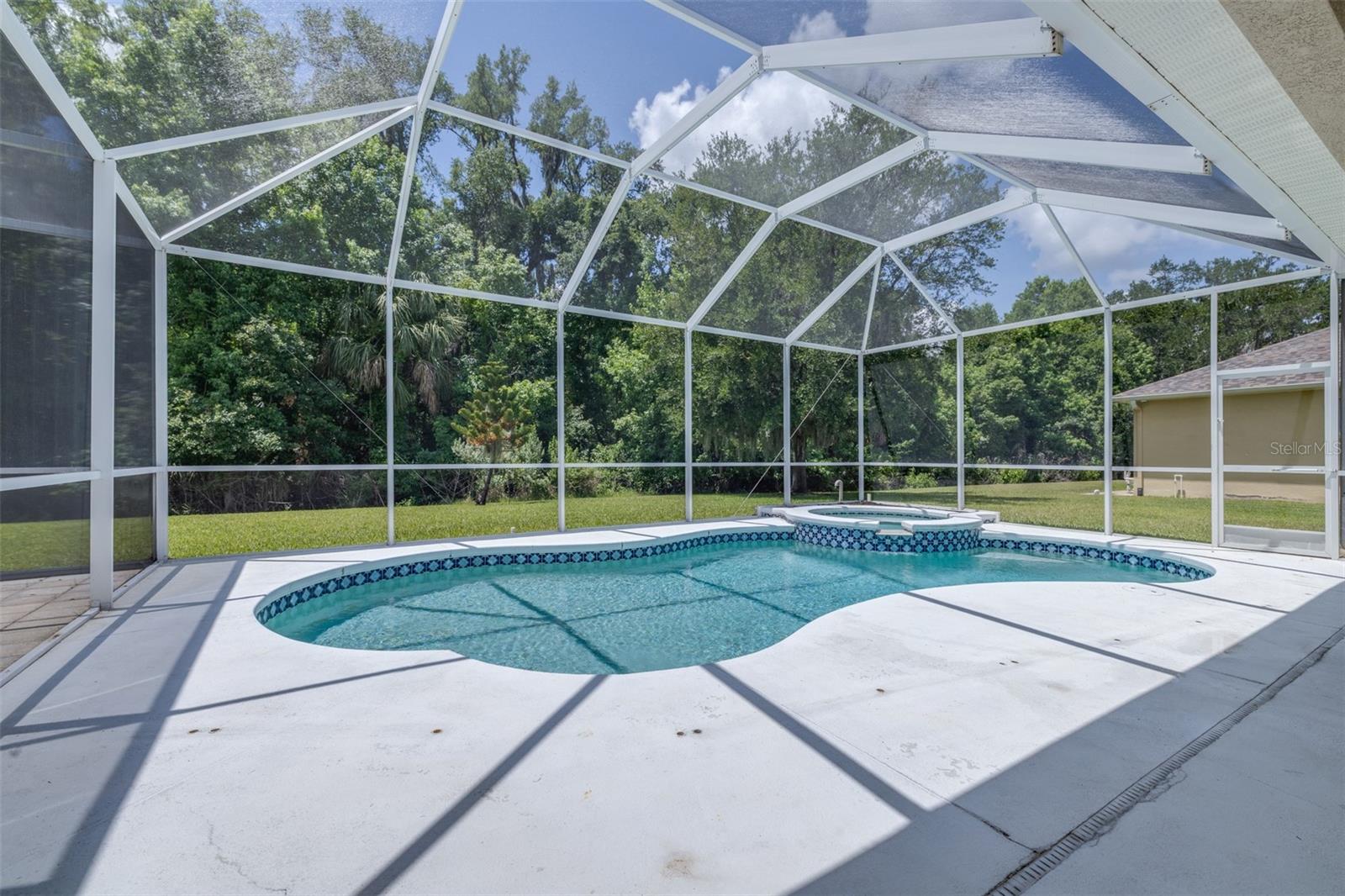Screened pool and spa area overlooking peaceful conservation views