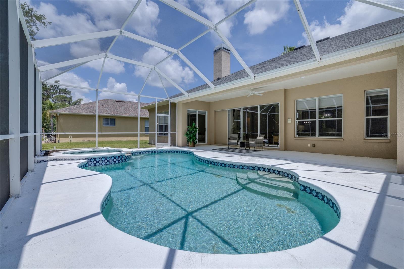 Screened pool/spa area overlooks conservation behind the home