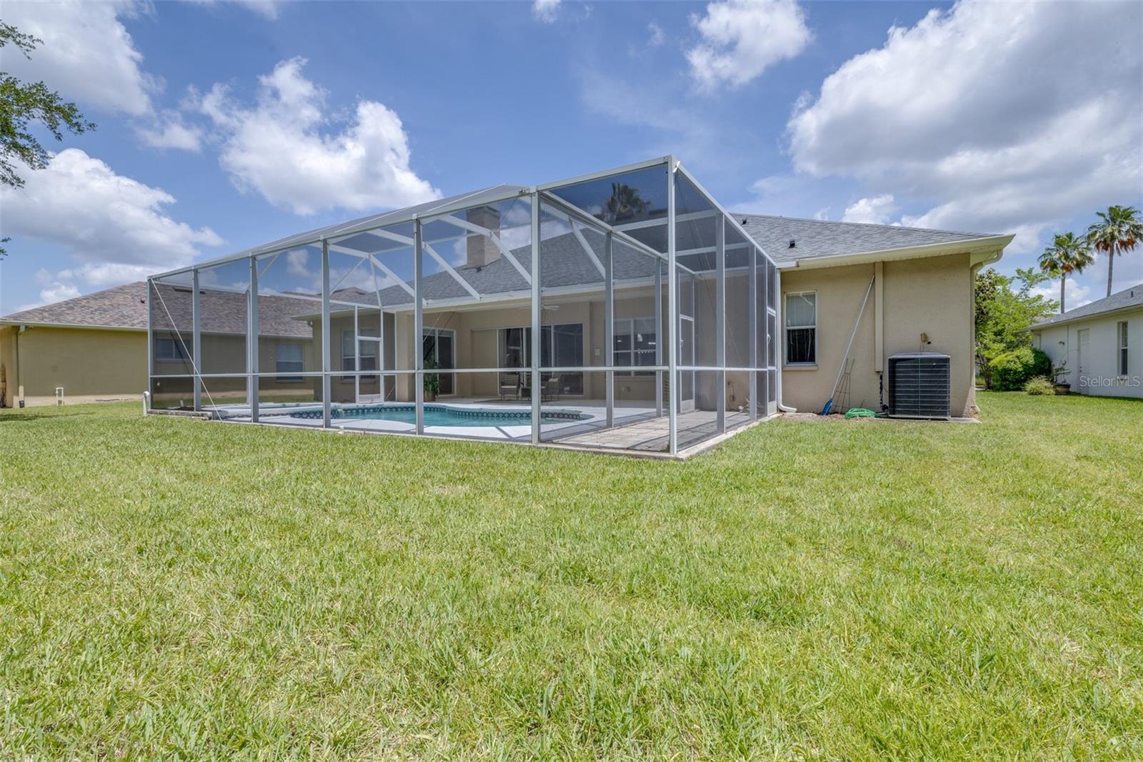 Large back yard with screened in pool