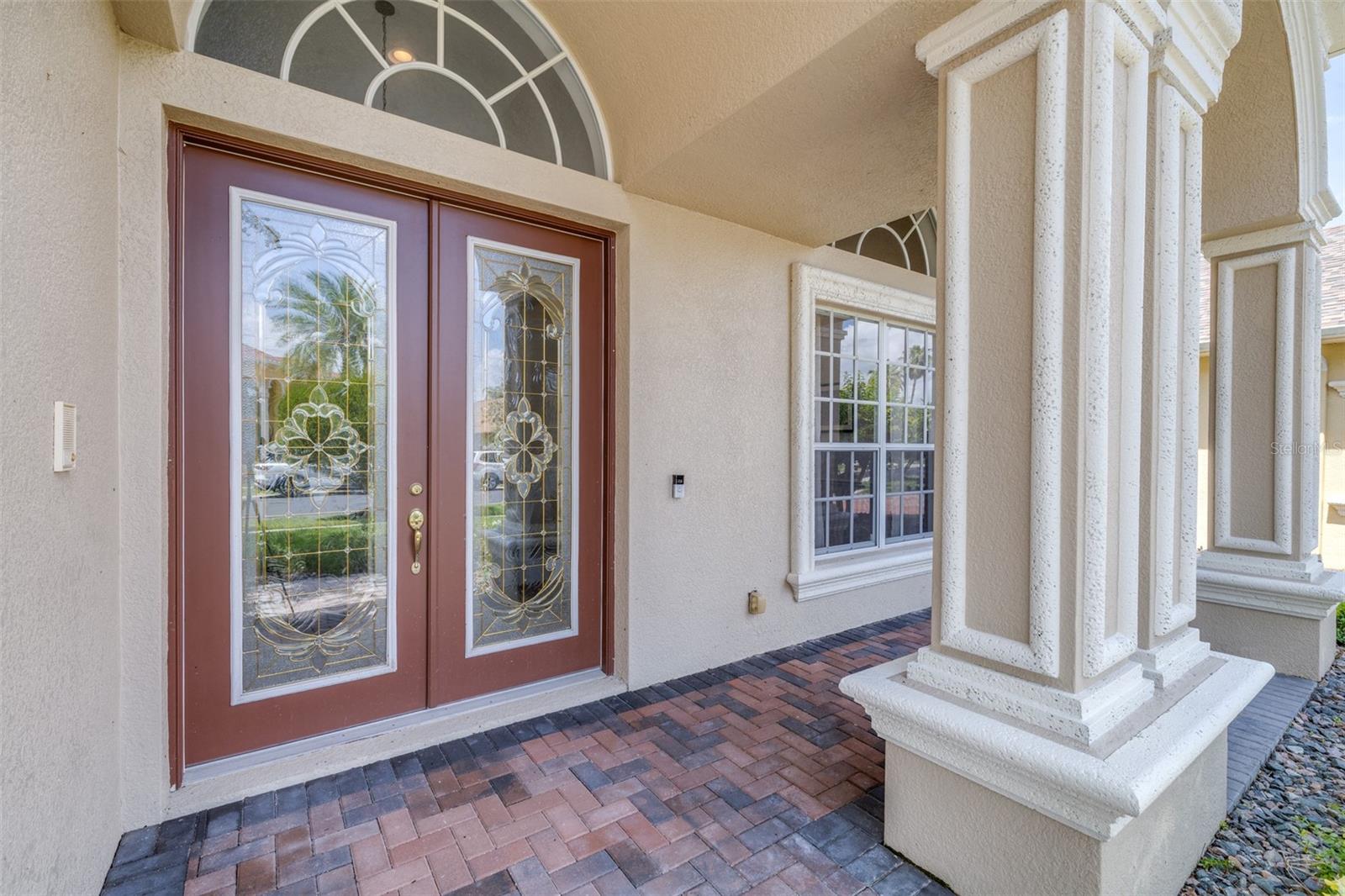 Covered front porch and decorative French doors