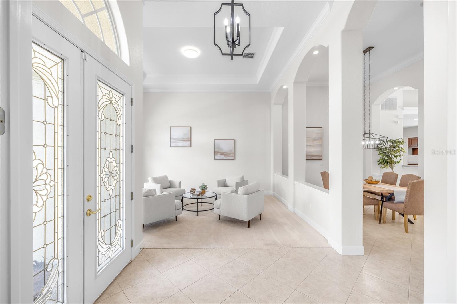 Grand foyer with high ceilings and natural light