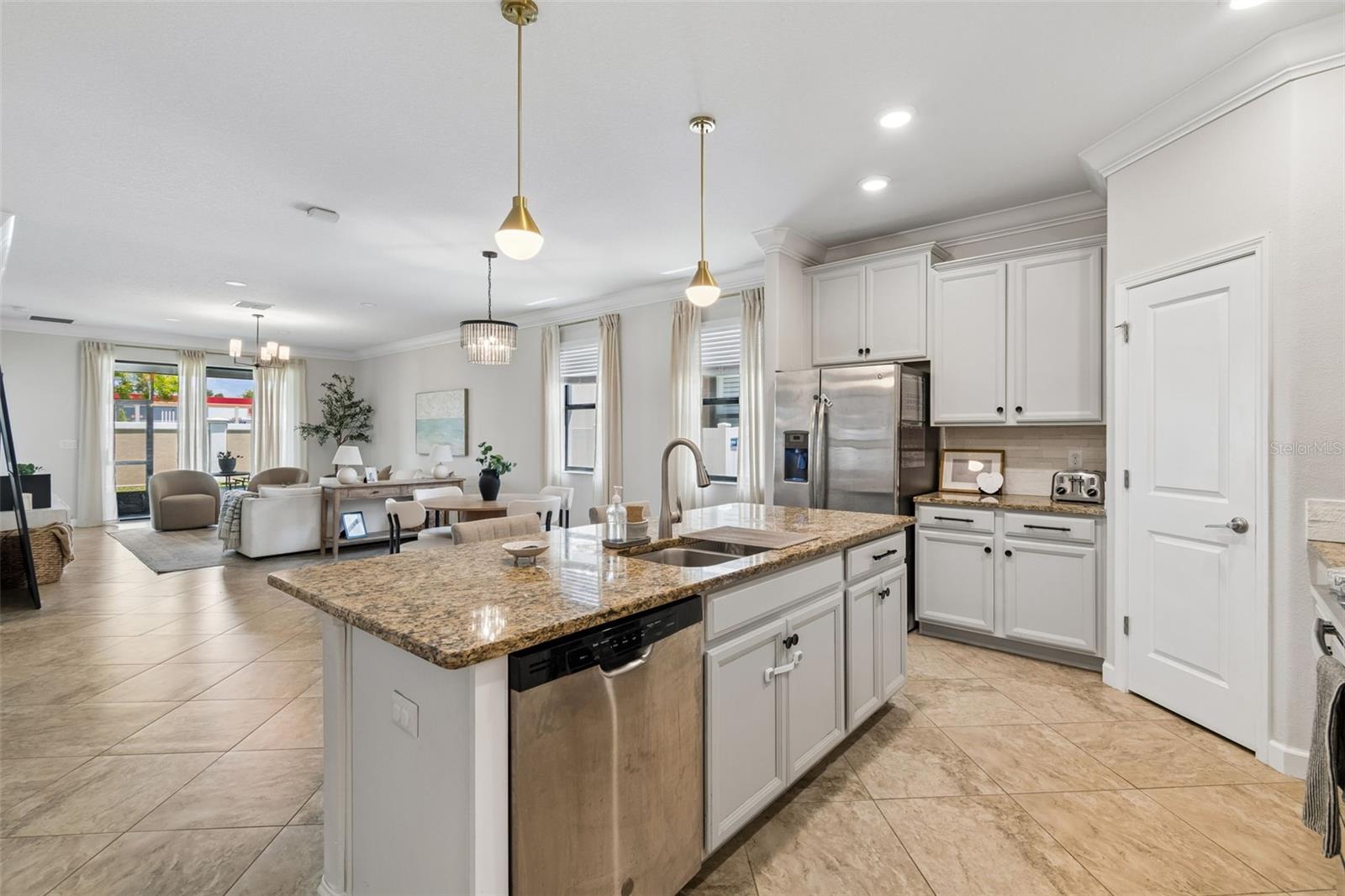 Integrated gourmet kitchen and living space with premium stainless steel appliances