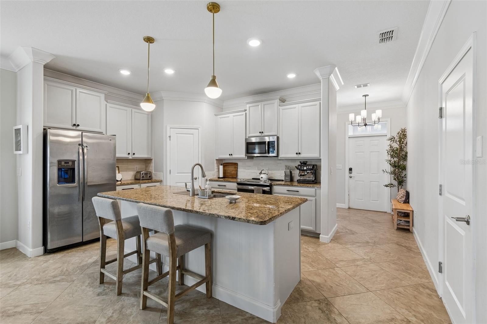 Open-layout kitchen featuring granite countertops and premium stainless steel appliances