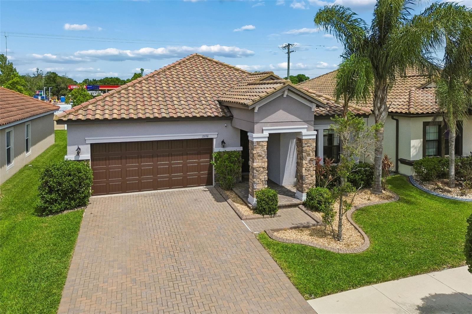 Stunning curb appeal with a stone-accented entryway.