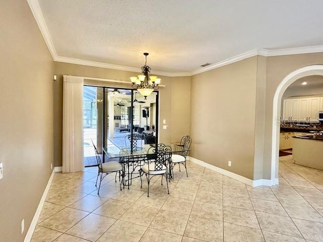 Formal Dining Area w/Dinner Table Furniture. Crown Molding throughout.