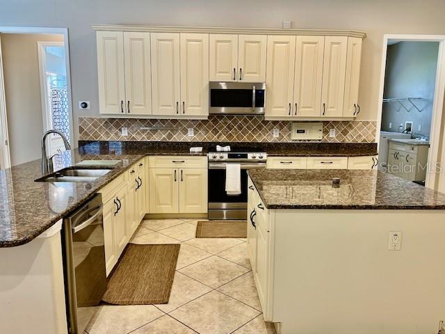 Kitchen Area w/Stainless Steel Appliances and Granite Countertops and Tile Floors