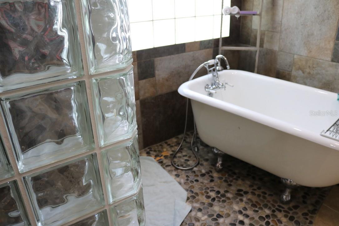 Claw Foot Tub on Stone floor in Primary Bath