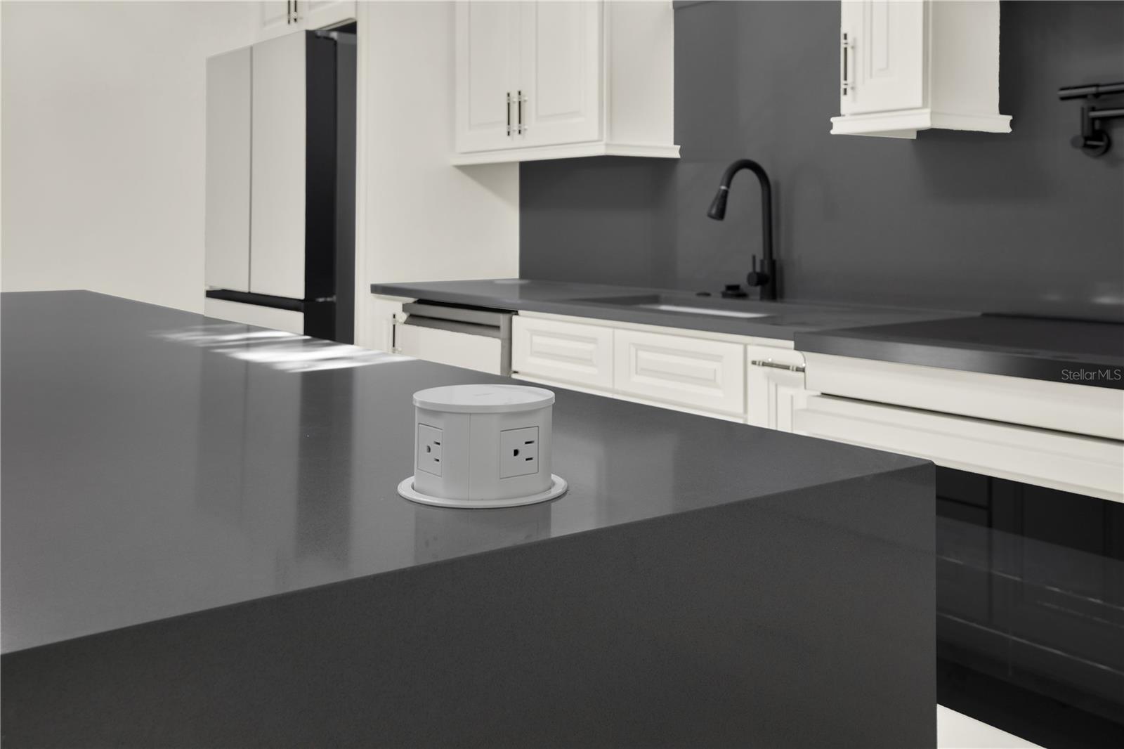 Sleek pop-up outlets throughout the kitchen.