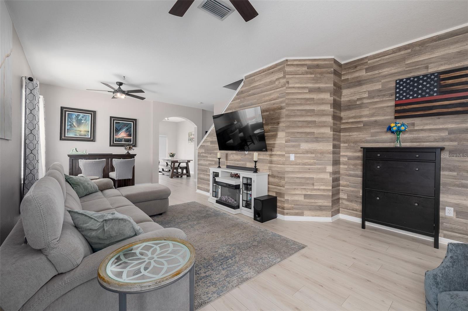 Downstairs Spacious Living Room with Beautiful Waterproof Laminate Flooring and Accent Wall!