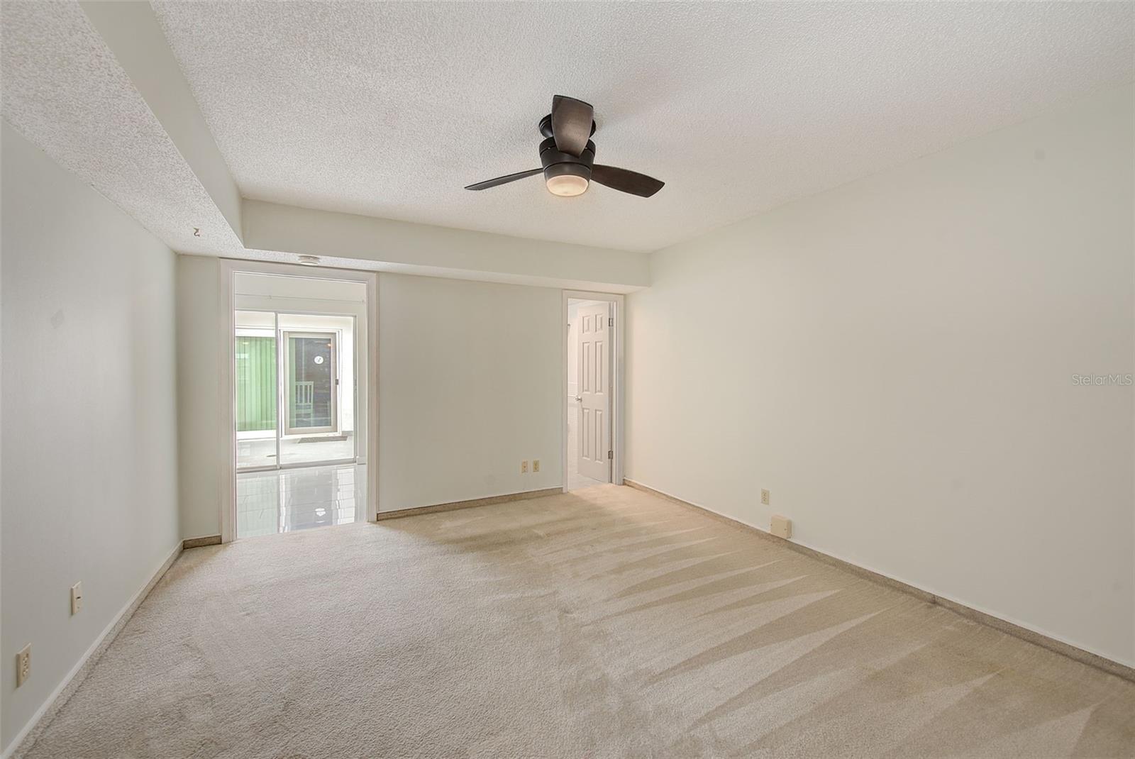View of master bedroom, bathroom and doorway to family room