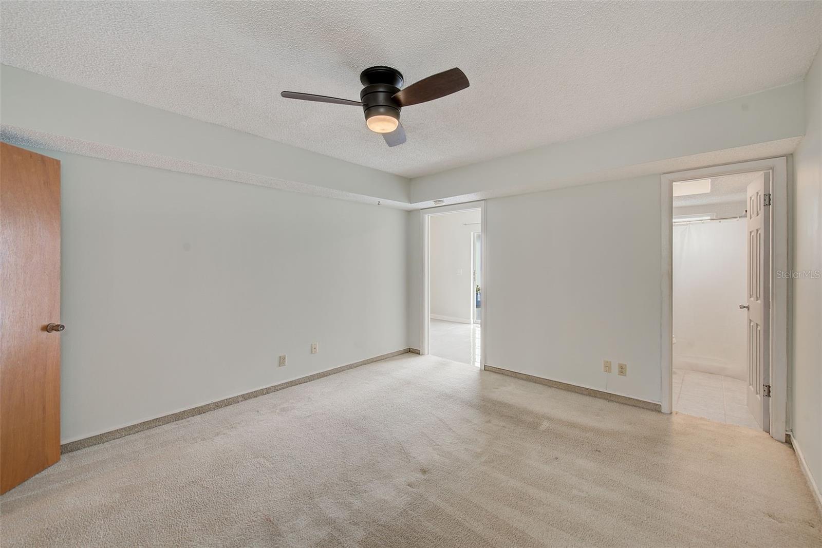 View of master bedroom, bathroom, and door to family room