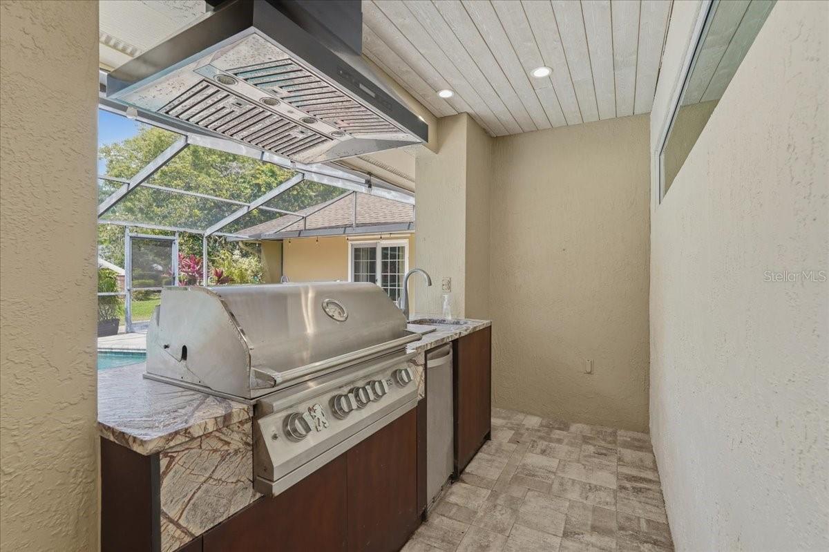 BEAUTIFUL OUTDOOR KITCHEN WITH A GRILL, AND OUTDOOR SINK!