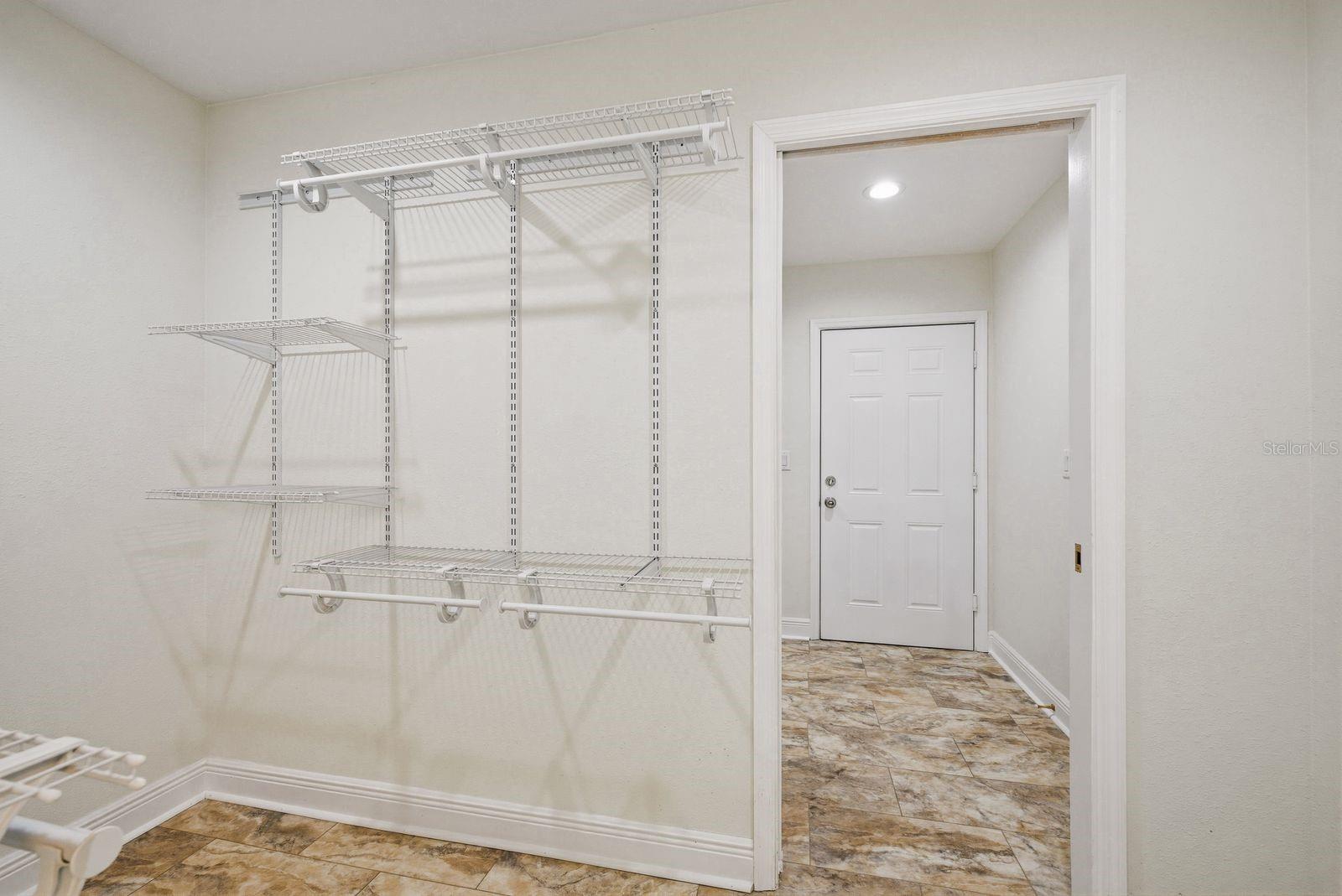 Primary bedroom walk in closet