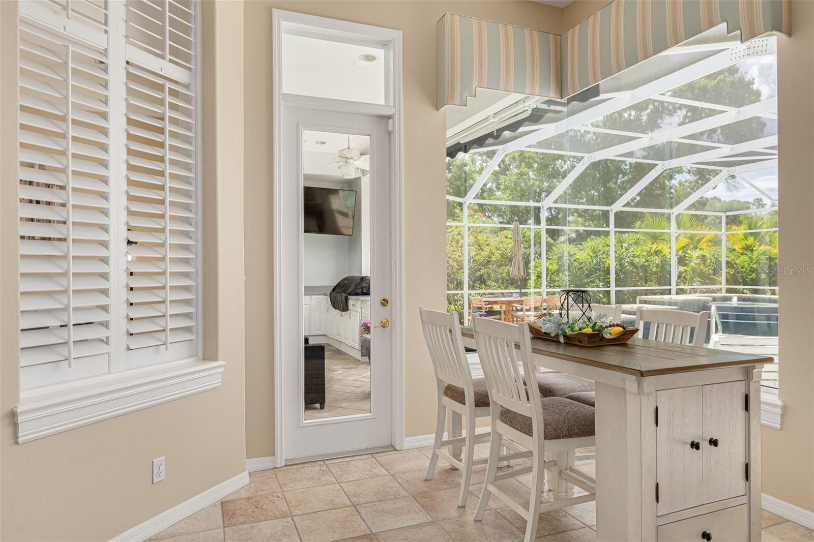 Eat-in kitchen overlooks the pool and outdoor lounge!