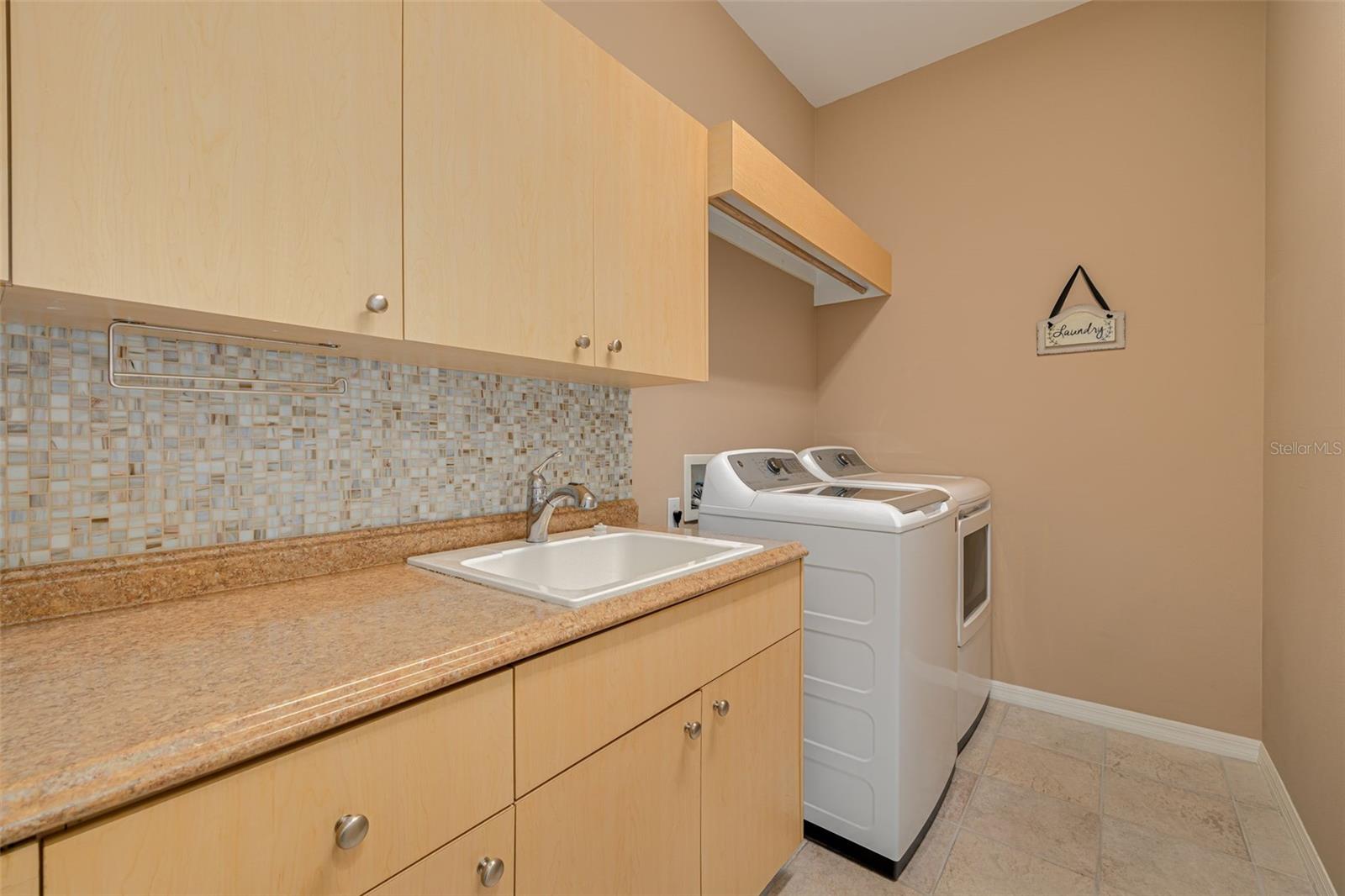 Laundry room with plenty of cabinet space.