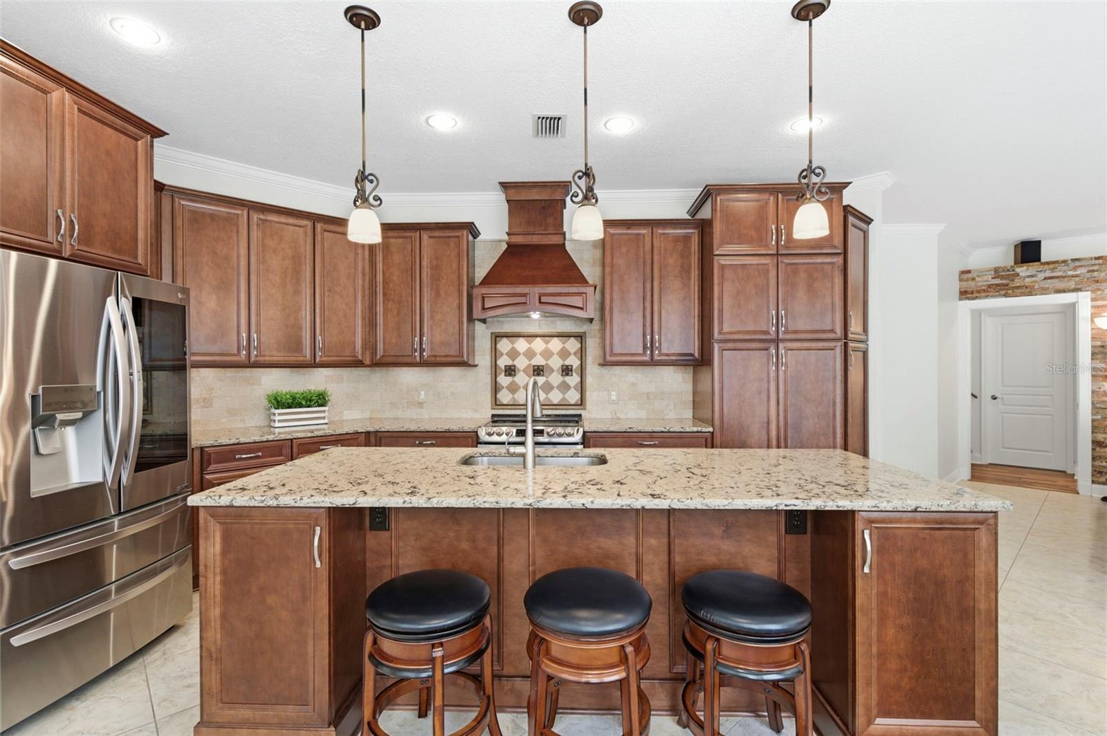 Spacious chef’s kitchen with oversized island and bar seating